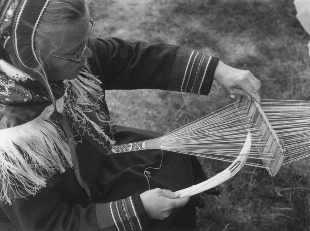 Teacher and pioneer of Sàmi education rights Edel Hætta Eriksen weaving using a reindeer horn heddle and shuttle. 1956 Photo Unni Fürst