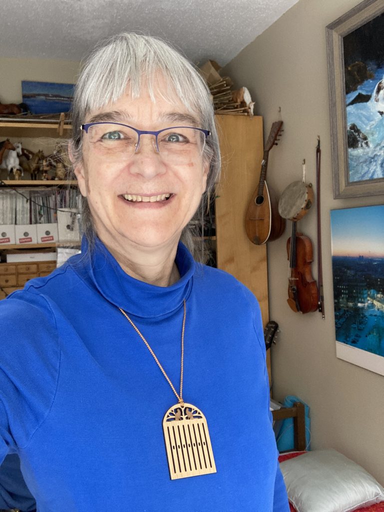 A photo of me wearing a heddle necklace